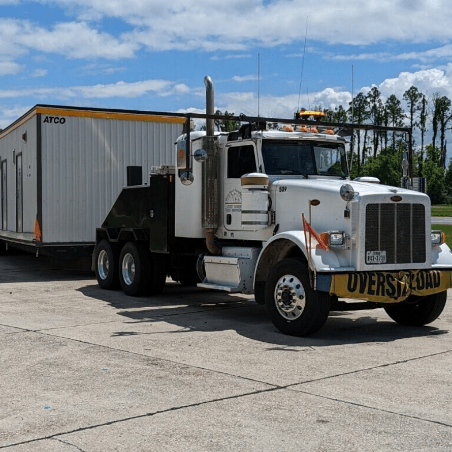 White Toter Truck with House At The Back with Willda Beast Logo on the Side Square