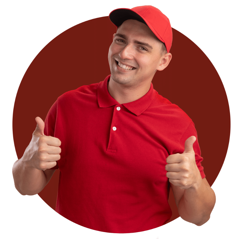 Smiling Young Delivery Man Wearing Red Uniform Polo Shirt and Red Cap doing Thumbs Up Sign