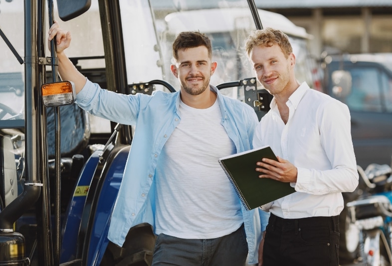 Two Male Standing Beside a Fork Lift